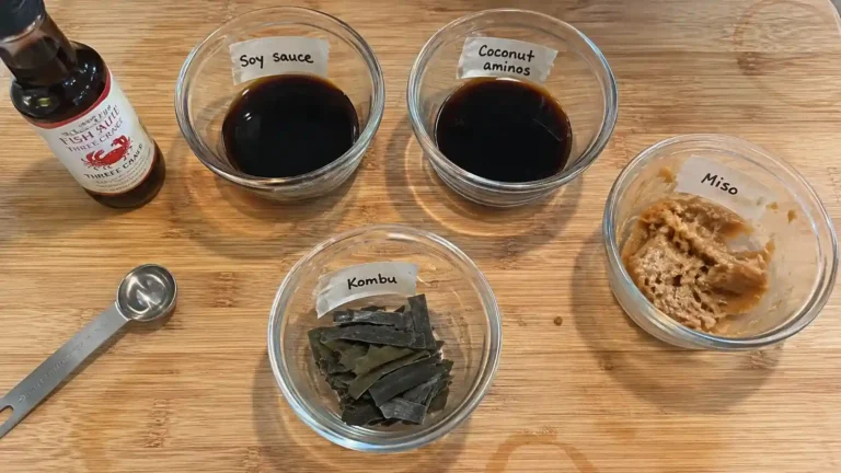fish sauce substitute ingredients in small bowls on a wooden kitchen counter
